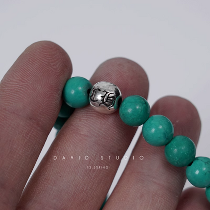 TURQUOISE BEAD BRACELET 8MM (4 SILVER BEADS)